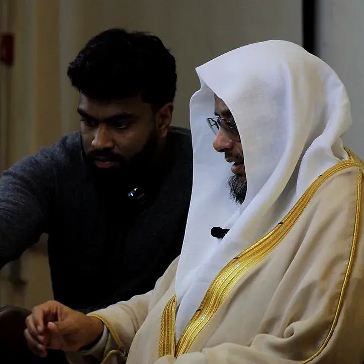 A visiting scholar sitting with a student